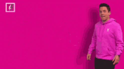A Man In A Pink Hoodie Is Pointing To The Word Pink GIF