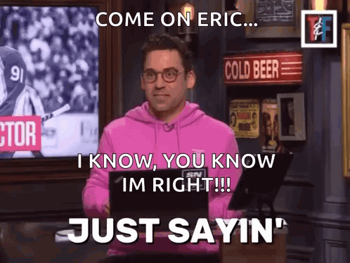 A Man In A Pink Hoodie Is Standing In Front Of A Sign That Says Cold Beer GIF