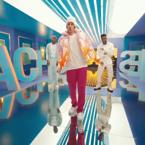 A Man In A Pink Jacket And Pink Pants Is Dancing In A Room With The Letters Ac On It GIF