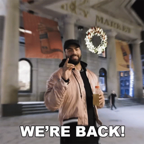 Pink Jacket Man Holding Bottle Saying We're Back GIF