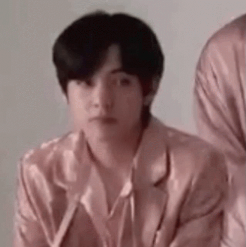 A Man In A Pink Jacket Is Sitting Next To Another Man In A Pink Jacket . GIF