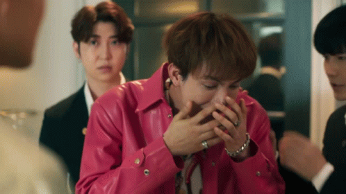 A Man In A Pink Leather Jacket Is Covering His Face With His Hands GIF