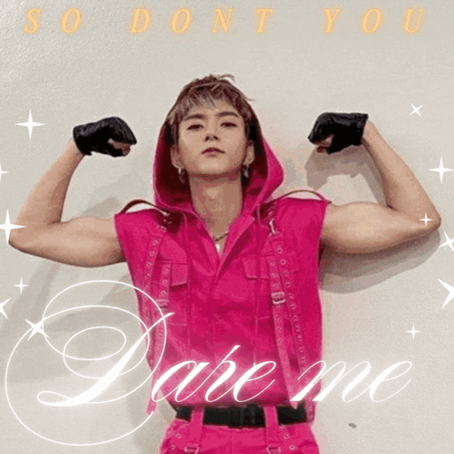 A Man In A Pink Outfit Is Flexing His Muscles And The Words Dare Me Are Behind Him GIF