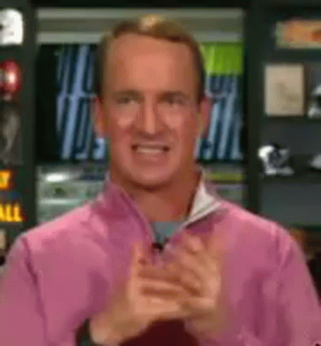 A Man In A Pink Shirt Is Clapping And Smiling GIF