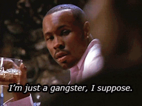 A Man In A Pink Shirt Is Holding A Glass Of Beer And Says I 'M Just A Gangster I Suppose GIF