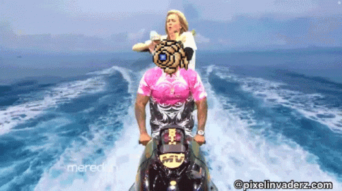 A Man In A Pink Shirt Is Riding A Jet Ski With A Woman On The Back GIF