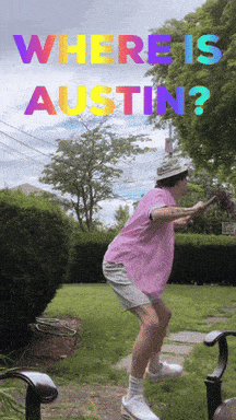 Pink Shirt Man Standing In Front Of Where Is Austin Sign GIF