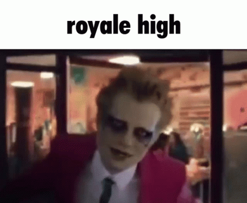 A Man In A Pink Suit And Tie Is Standing In Front Of A Window With The Words `` Royale High '' Written On It . GIF