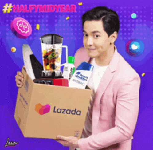 A Man In A Pink Suit Is Holding A Lazada Box Full Of Items GIF