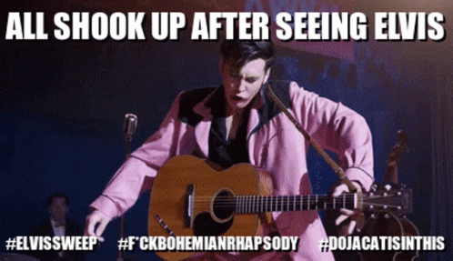 A Man In A Pink Suit Is Playing A Guitar And Says All Shook Up After Seeing Elvis GIF
