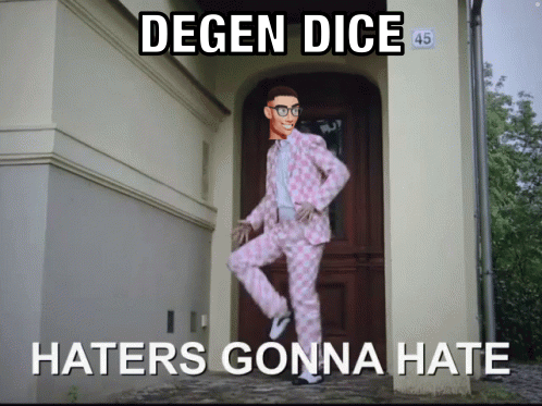 A Man In A Pink Suit Is Standing In Front Of A Door With The Words Degen Dice Haters Gonna Hate GIF