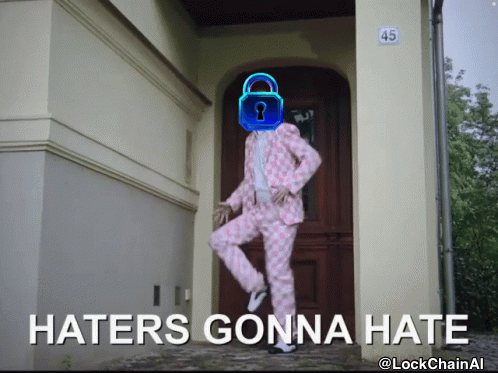A Man In A Pink Suit Is Standing In Front Of A Door With The Words Haters Gonna Hate Written On The Bottom GIF