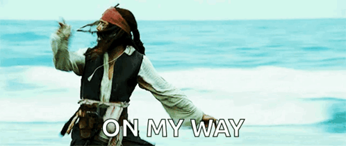 A Man In A Pirate Costume Is Dancing On The Beach With The Words On My Way Written Below Him GIF