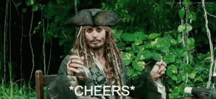 A Man In A Pirate Costume Is Sitting In A Chair Holding A Glass Of Wine And A Cigarette . GIF