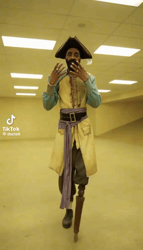 A Man In A Pirate Costume With A Prosthetic Leg Takes A Picture Of Himself GIF