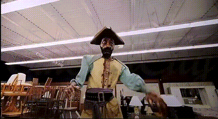 A Man In A Pirate Outfit Is Standing In A Room GIF