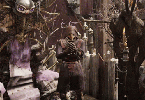 A Man In A Plague Doctor Costume Stands In Front Of A Skeleton GIF
