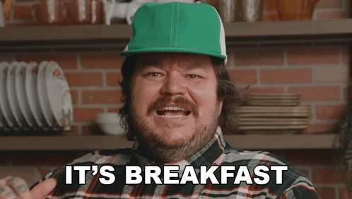 A Man In A Plaid Shirt And Green Hat Says It 'S Breakfast GIF