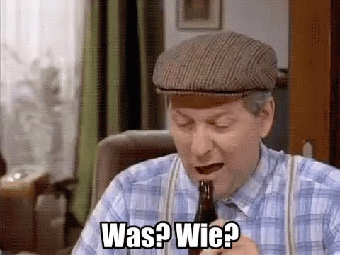 A Man In A Plaid Shirt And Hat Is Holding A Bottle Of Beer And Asking Was ? Wie ? GIF