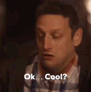 A Man In A Plaid Shirt And Tie Is Saying Ok . Cool . GIF