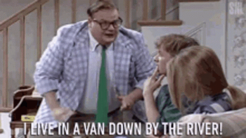 A Man In A Plaid Shirt And Tie Is Standing In Front Of A Group Of Children . GIF