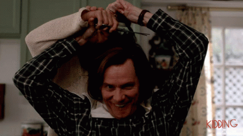 A Man In A Plaid Shirt Is Cutting A Woman 'S Hair With The Words Kidding Written On The Bottom GIF
