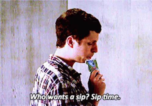 A Man In A Plaid Shirt Is Eating An Ice Cream Cone And Says Who Wants A Sip GIF
