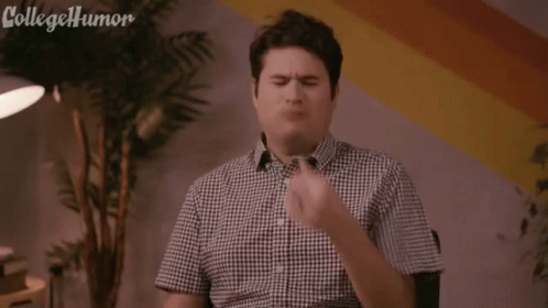 A Man In A Plaid Shirt Is Holding A Piece Of Coal In His Mouth And Says Ug , Black Lung . GIF