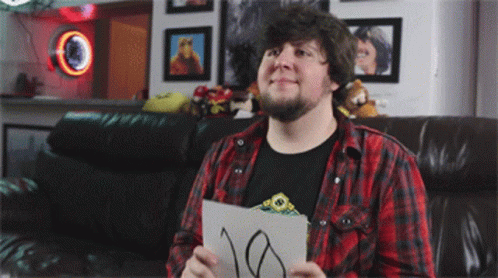 A Man In A Plaid Shirt Is Holding A Piece Of Paper With The Number 10 Written On It GIF