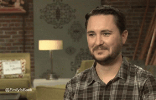 Man In Plaid Shirt Laughing With Emily's Bach Text GIF