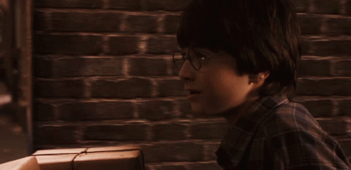 a man in a plaid shirt is looking at something in the distance