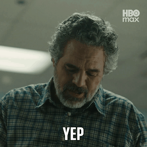 A Man In A Plaid Shirt Is Making A Yep Gesture GIF