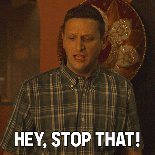 A Man In A Plaid Shirt Is Saying " Hey Stop That " GIF