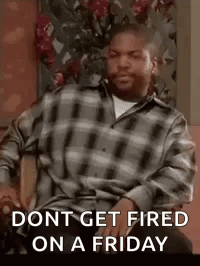 a man in a plaid shirt is sitting in a chair with the words `` dont get fired on a friday '' .