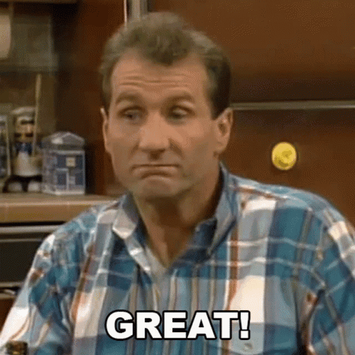 Man In Plaid Shirt Sitting In Kitchen GIF