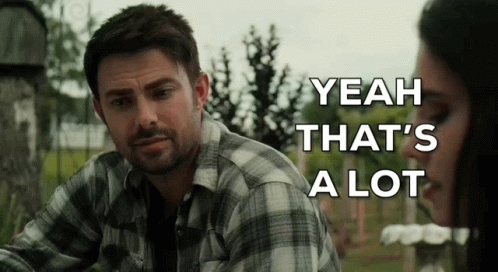 A Man In A Plaid Shirt Is Sitting Next To A Woman In A Cemetery . GIF