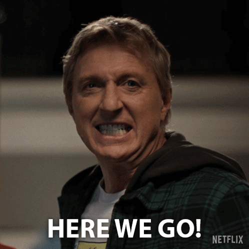 A Man In A Plaid Shirt Is Smiling And Says Here We Go Netflix GIF