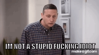 A Man In A Plaid Shirt Is Standing In A Room And Says `` I 'M Not A Stupid Fucking Idiot '' GIF
