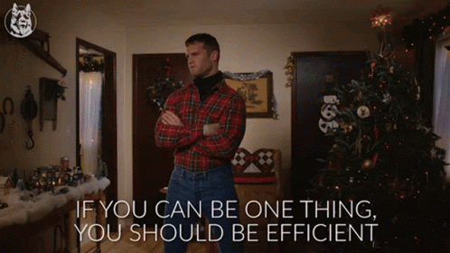 A Man In A Plaid Shirt Is Standing In Front Of A Christmas Tree With The Words If You Can Be One Thing You Should Be Eff GIF
