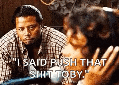 A Man In A Plaid Shirt Is Talking To A Woman Who Is Holding A Baby . GIF