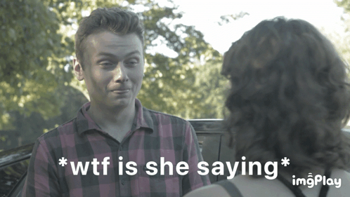 A Man In A Plaid Shirt Is Talking To A Woman Who Is Saying " Wtf Is She Saying * " GIF