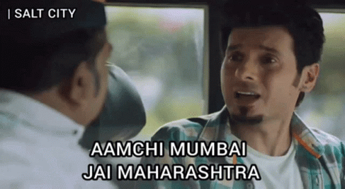 A Man In A Plaid Shirt Is Talking To Another Man With The Words Aamchi Mumbai Jai Maharashtra On The Bottom GIF