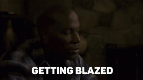 A Man In A Plaid Shirt Says Getting Blazed In A Dark Room GIF