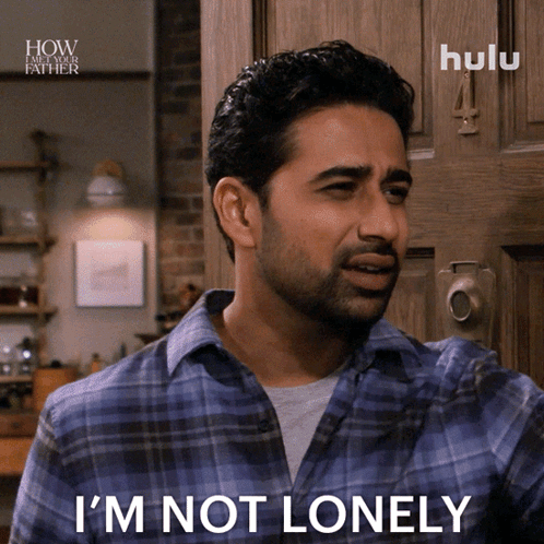 A Man In A Plaid Shirt Says I 'M Not Lonely In Front Of A Door GIF