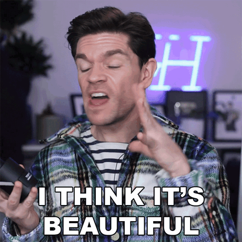 A Man In A Plaid Shirt Says " I Think It 'S Beautiful " While Holding A Camera GIF