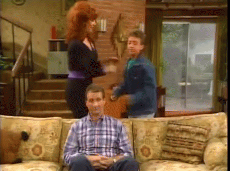 Man In Plaid Shirt Sitting On Couch GIF