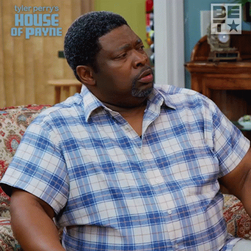 A Man In A Plaid Shirt Sits On A Couch With The Words Tyler Perry 'S House Of Payne GIF
