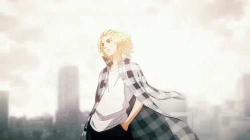 A Man In A Plaid Shirt Stands In Front Of A Cityscape GIF