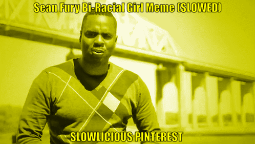 A Man In A Plaid Sweater Stands In Front Of A Building With The Caption " Sean Fury Bi-Racial Girl Meme Slowed " GIF