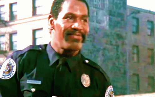 A Man In A Police Uniform Has A Patch On His Chest That Says ' Metropolitan Police ' GIF
